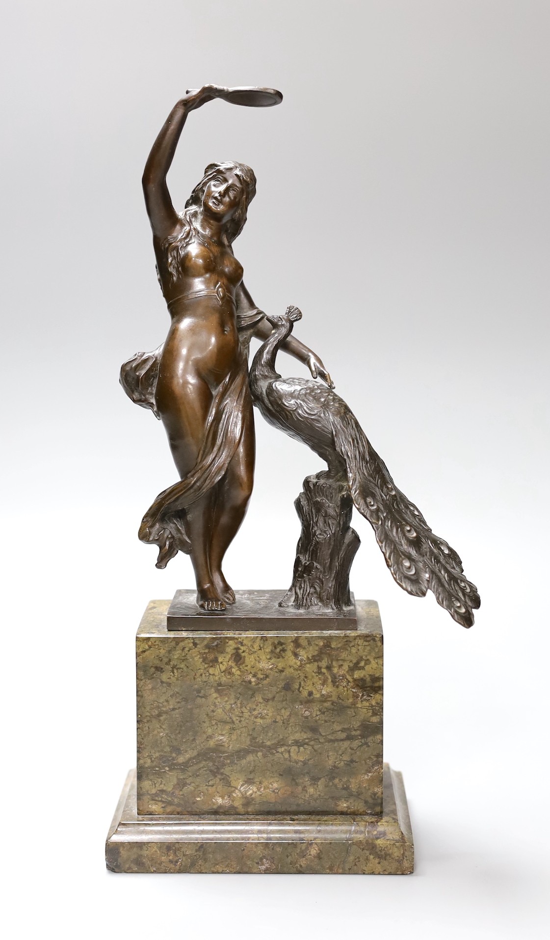 A bronze female and peacock group on plinth base, 32cm tall